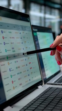 Procurement Manager Using Multiple Computer Screens Analyzing Supplier Data