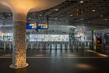 Obraz premium Ticket barriers and signage in modern Rotterdam Centraal Railway Station concourse, Rotterdam. Netherlands