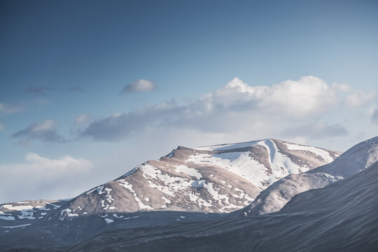 Rocky mountain slopes in the Pamir Mountains in Tajikistan, a minimalist landscape and rocky hills in sunny weather