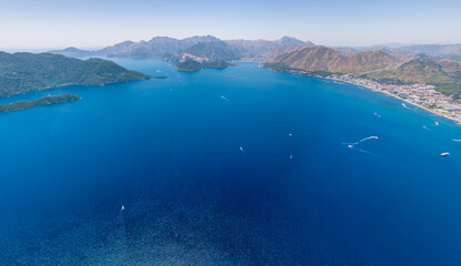 Obraz premium Marmaris, Turkey. Panoramic aerial view of the bay entrance system with Nimara and Keci islands, forested mountains, and turquoise waters under bright summer sun