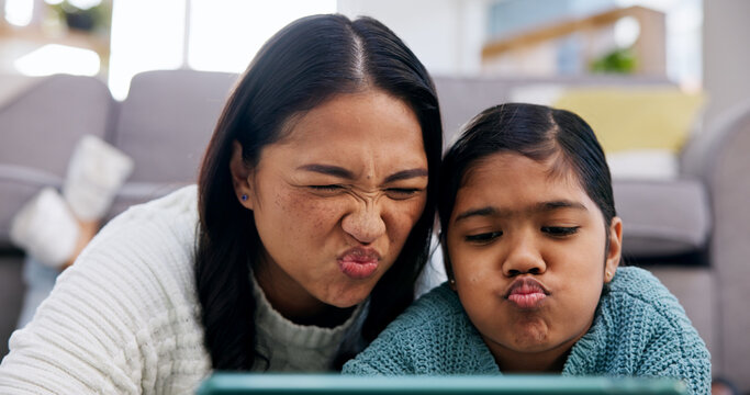 Daughter, mother and selfie with tablet in living room of home for bonding or memories. App, funny face and picture of pouting girl child with single parent woman in apartment for family humor