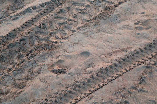 Tire tracks in sand - Vehicle tread marks on sandy terrain texture