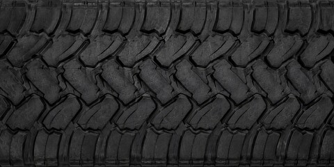 High-resolution close-up of a large black truck tire tread texture featuring deep rugged grooves and durable rubber patterns. © RAMANAN