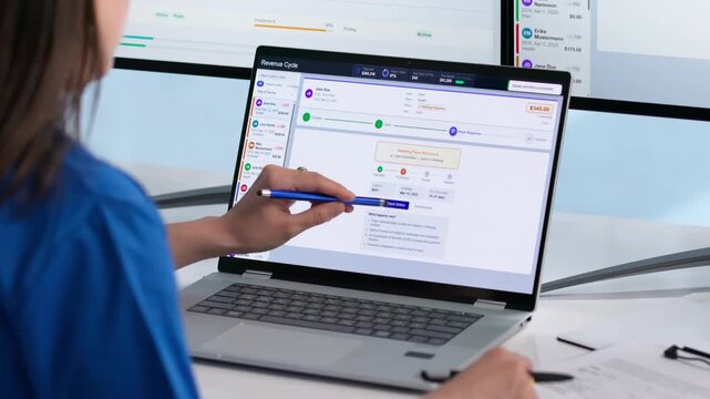Healthcare Manager Reviews Patient Billing Details On Laptop