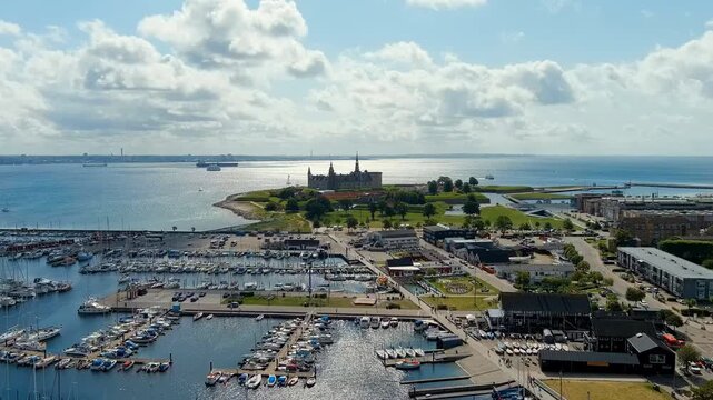 Helsingor, Denmark. Kronborg Castle, a Renaissance fortress with sandstone walls and copper roofs, Drone footage over the Oresund Strait under bright summer skies. Drone footage