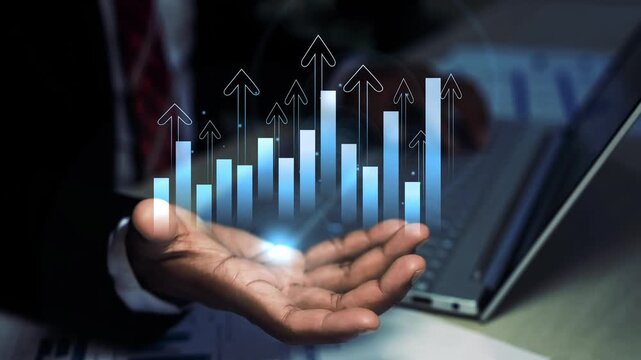 Businessman hand holding a glowing holographic bar chart with rising arrows on the screen, Hand holding business growth success data and financial progress