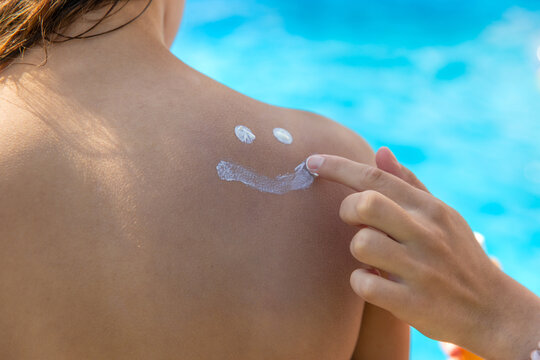 Sunscreen cream on the back of the sun. Selective focus.