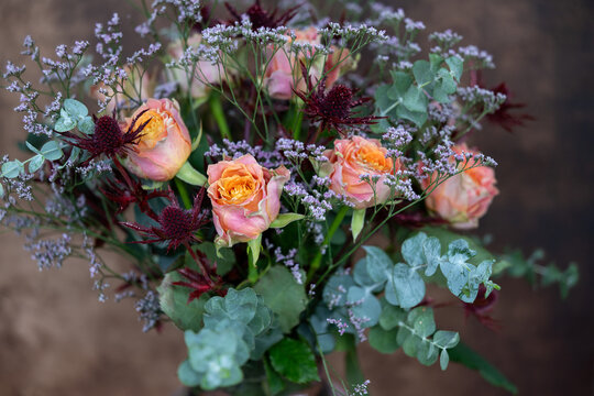 Beautiful bouquet of roses with eucalypthus and thistles - background for flost purposes or greeting cards
