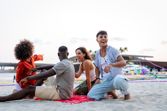 Friends enjoying a fun travel adventure on a tropical beach at sunset, making lasting memories