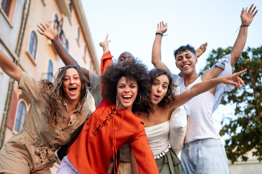 Multicultural group enjoys a carefree moment while traveling together, sharing laughter in the city