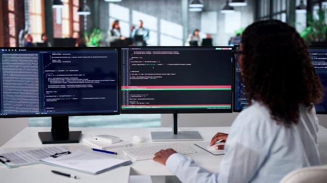 Software Developer Reviews Code Differences Using Visual Merge Tool