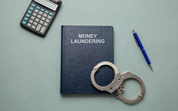 Money laundering concept, financial crime, law enforcement, calculator and handcuffs