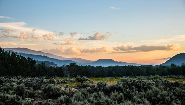 Hazy mountain layers at sunset over desert landscape
