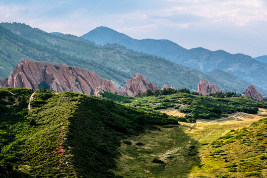 Dramatic red rocks and rolling green hills