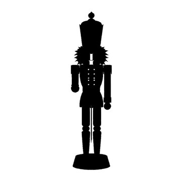 A black silhouette of a traditional nutcracker soldier standing on a white background