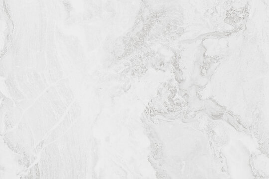 Horizontal close up overhead view of a seamless white marble stone texture with natural elegant grey veins and mineral patterns for luxury interior design