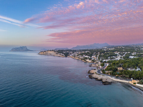 Aerial Mediterranean Coastline at Pink Sunset Over Coastal Moraira, Spain