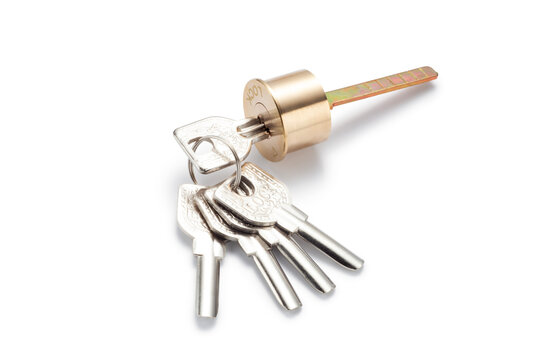 A brass cylinder door lock with set of five keys isolated on white background