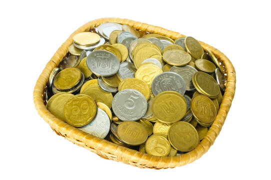 Many ukrainian kopeks, hryvnia cents, in a little basket, isolated on white background