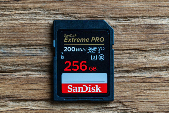 High-performance SanDisk Extreme PRO 256GB SDXC UHS-I memory card with 200 MB s speed capacity, placed horizontally on textured wooden background