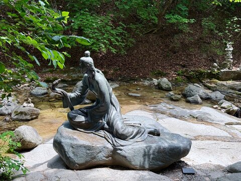 Chuncheon, South Korea - June 24, 2026: The statue that depicts the story of Princess Pyeongyang and the man who loved her and turned into a lovesick snake clinging onto her around Goryeoseonwon
