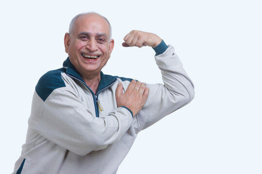 Portrait of old man flexing muscle