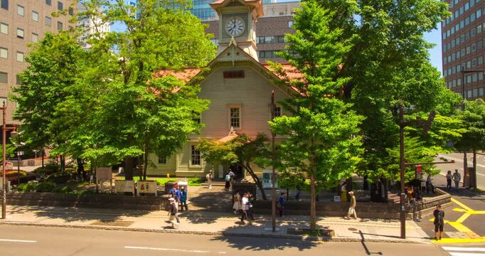 Sapporo Clock Tower Day Timelapse: Historic Wooden Building with Summer Trees and Pedestrians, Hokkaido, Japan - Wide Angle Shot
