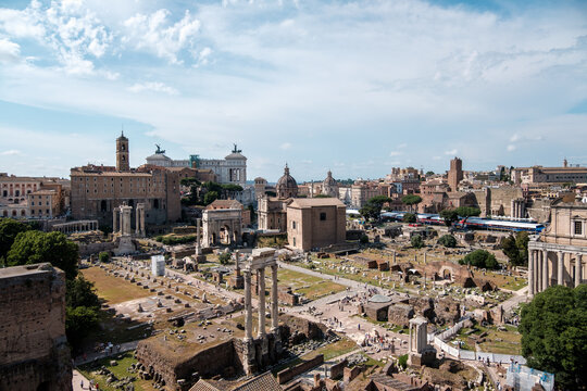 High angle panoramic view over the ancient ruins of the Roman Forum under a bright sky in Rome Italy