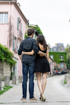 France, Paris, young couple in an alley in the district Montmartre