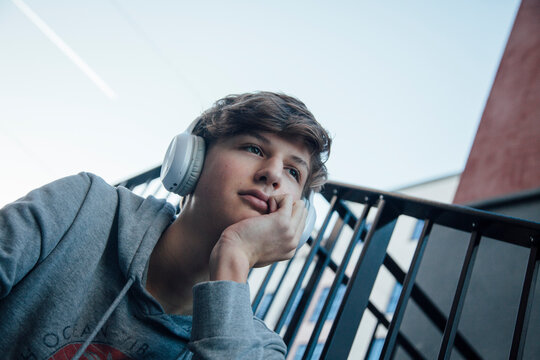 Portrait of teenager with headphones, thoughtful