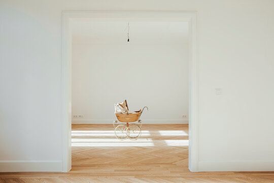 Pram in empty room, open doors