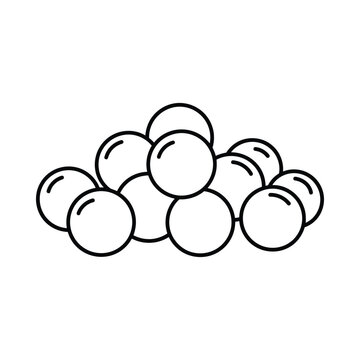 A group of round objects are clustered together in a pile on a surface.