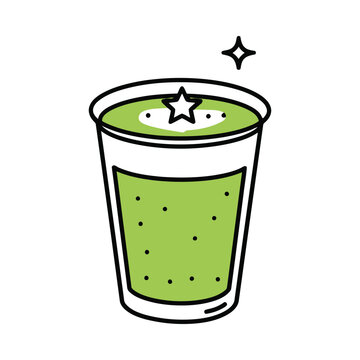 A refreshing green drink with a star on top sits in a glass cup.