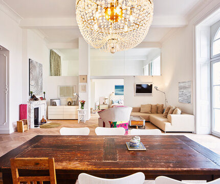 Living room in a refurbished old building with dining table in the foreground