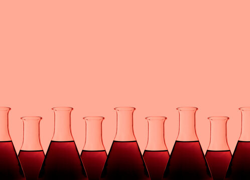 Row of test tubes with liquid, red background