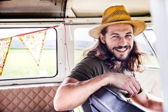 Portrait of happy young man inside a van