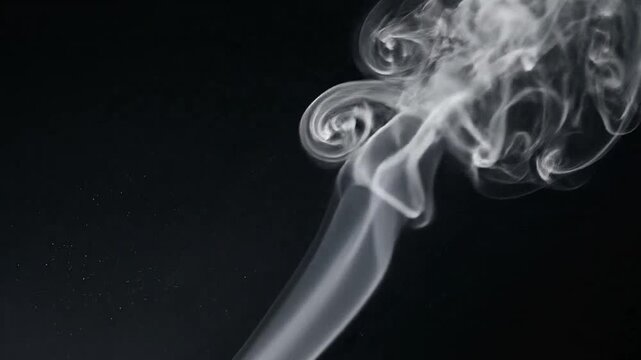 A delicate plume of white smoke rises against a dark background