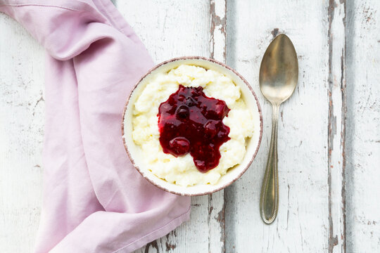 Bowl of rice pudding with cherry and berry groats