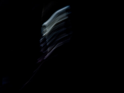 Abstract diagonal motion blur with dynamic white light trails. High-speed shutter effect long exposure on black background.