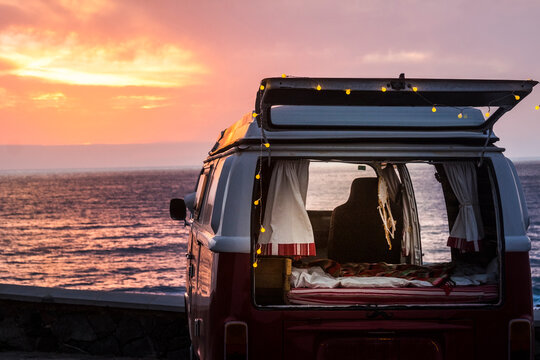 Vinage camper with a dream catcher at the sea at sunset