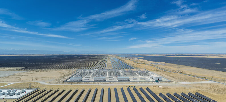 Aerial View of Integrated Solar Farm with Energy Storage and Substation in Desert-Edge Gobi for Sand Control and Power Generation