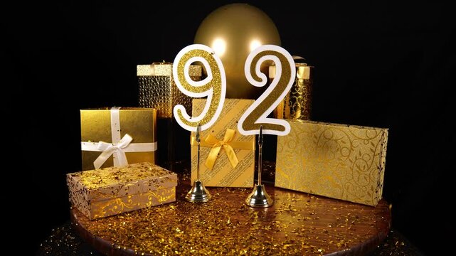 Gold Number 92 with Gold Glitter Confetti Sparkles with Gifts and Balloons for Party Ninety Two
