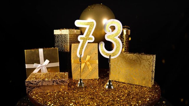 Gold Number 73 with Gold Glitter Confetti Sparkles with Gifts and Balloons for Party Seventy Three