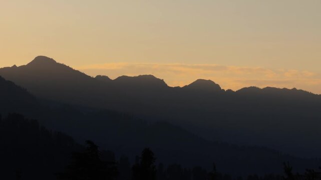 4K Silhouette shot of Himalayan mountain range during the sunset as seen from Kais Dhar near Kullu in Himachal Pradesh, India. Scenic view of sunset in the Himalayas. Natural background.