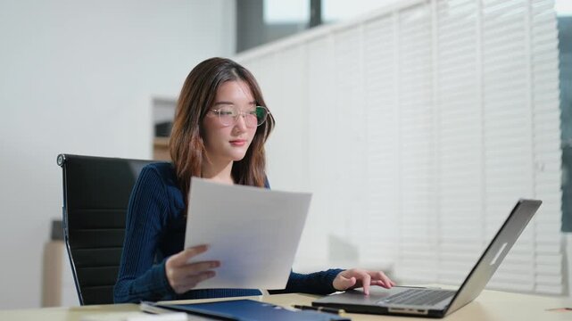 Business woman using tablet and laptop for doing math finance on an office desk, tax, report, accounting, statistics, and analytical research concept in office