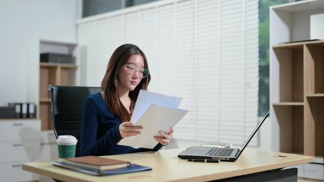 Asian lawyer consults with a client in a modern law office, discussing contracts, legal strategy, business compliance and corporate advisory during a professional meeting.