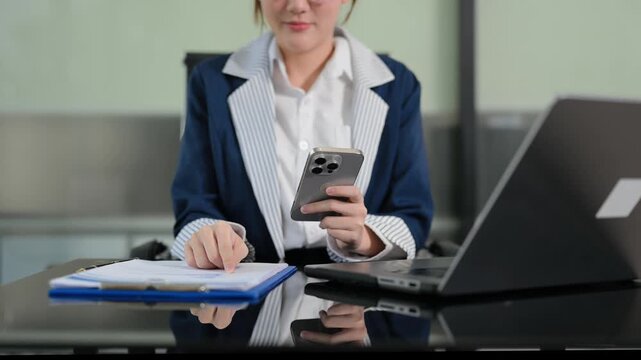 Women counting coins on calculator taking from the piggy bank. hand holding pen working on calculator to calculate on desk about cost at office.