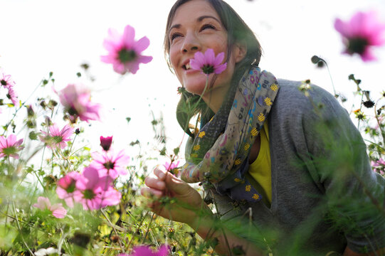Portrait of women smelling on wild flower, flower meadow