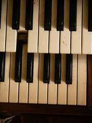 Aged broken vintage piano keyboard with damaged missing key and worn yellowed ivory surface evoking decay nostalgia forgotten music and instrument repair concept © Tavan