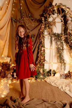 Laughing person in red dress at indoor Christmas studio